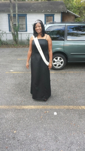 Marilynn Dawson looking glamorous and stunning with her tiara, elegant black dress, and Ms. Sigma Beta Delta sash |Image Credit: Marilynn Dawson